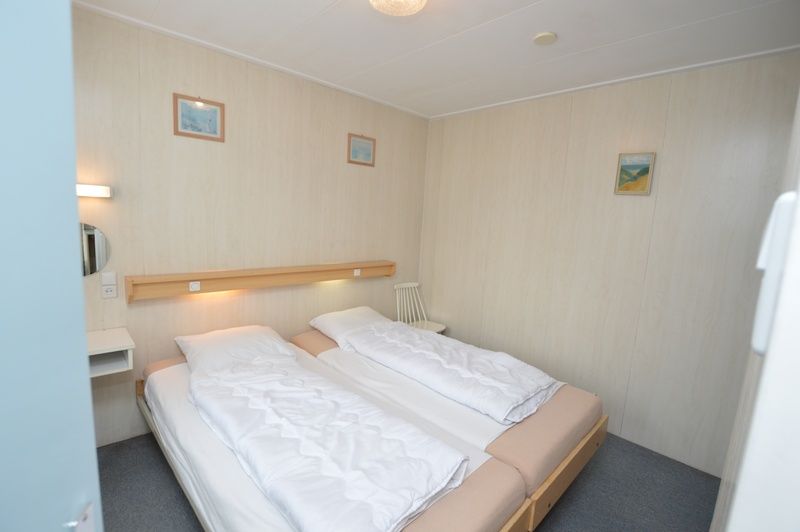 Bedroom with double bed in vacation home Plevierstraat 18, De Koog, Texel with quiet decoration.