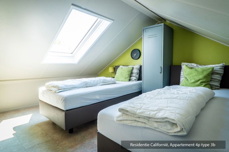 Attractive bedroom with two single beds in Type 3B vacation home, De Koog, Texel, with skylight for extra light.