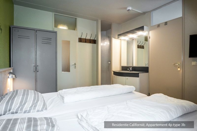 Master bedroom in Type 3B vacation home, De Koog, Texel, with double bed and modern sink.