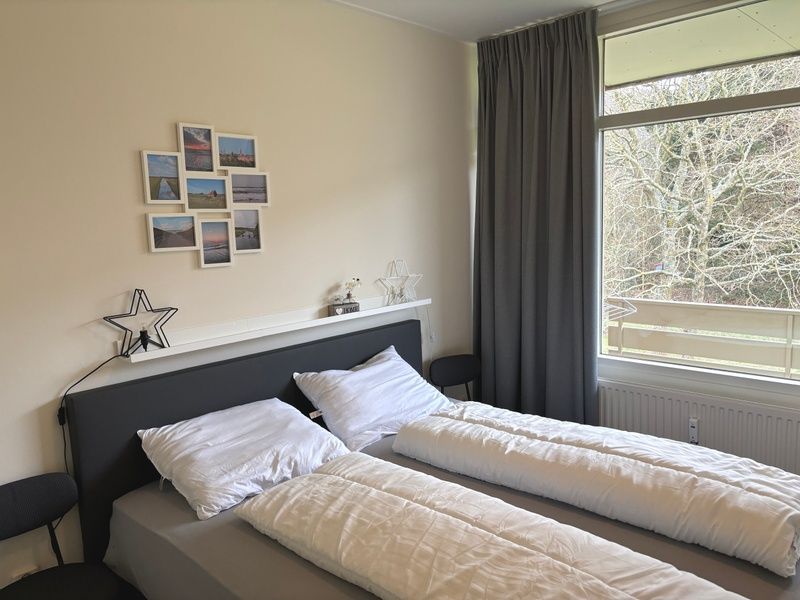 Bright bedroom in Apartment Kerckeland 40, De Koog, Texel with a view of nature.
