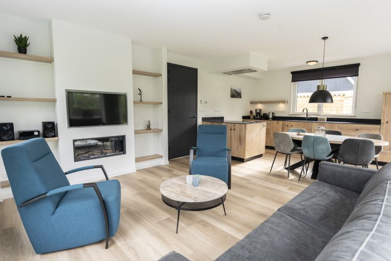 Modern living room of Villa 37, De Koog, Texel. Comfortable seating area in vacation home on the Wadden Islands.