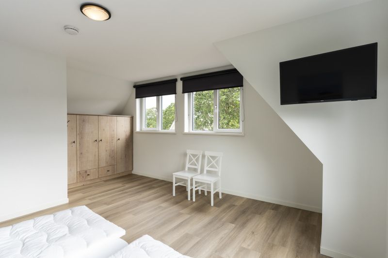 Spacious bedroom with view in Villa 37, De Koog, Texel. Vacation home on the Wadden Islands.
