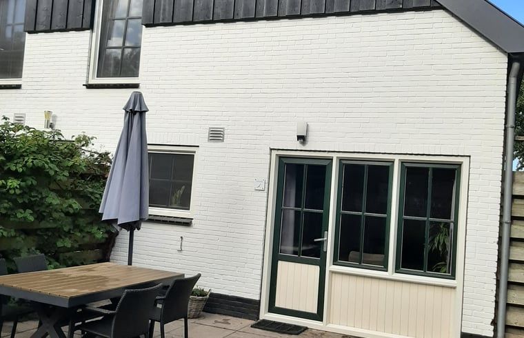 Cozy terrace of Cottage in De Koog on Texel, ideal for relaxing outdoor meals.