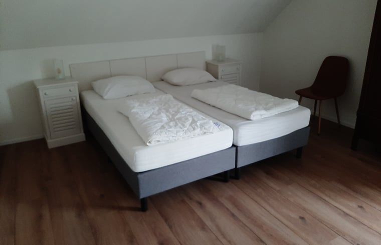 Modern kitchen in Cottage in De Koog, Texel, with sleek gray cabinets and a beautiful view.
