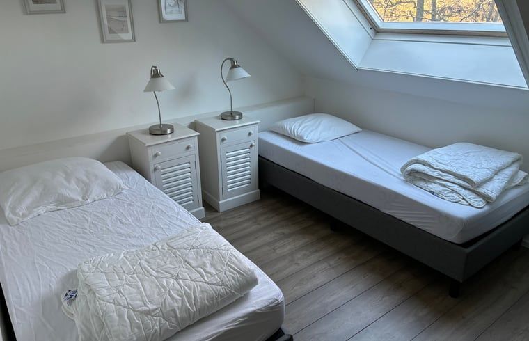 Stylish bedroom closet and natural light in Cottage in De Koog, Texel, for a relaxing stay.