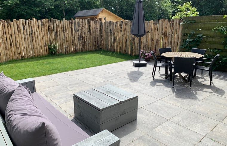 Spacious terrace with garden furniture and views of nature at Cottage in De Koog, Texel.