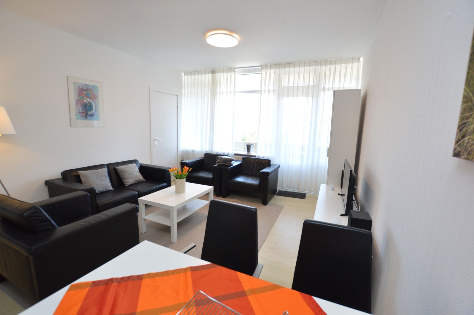 Spacious living room of Apartment Kerckeland 98, De Koog, Texel with a cozy atmosphere and plenty of seating.