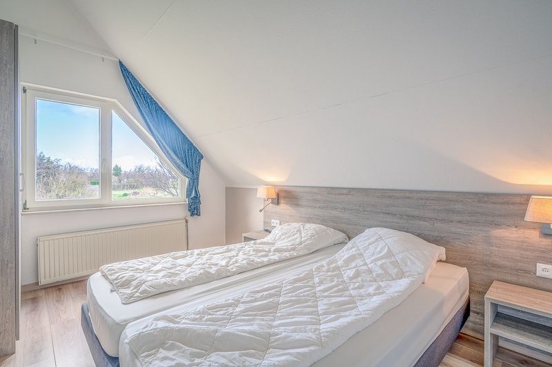 Welcoming bedroom in Holiday home Honeysuckle 55 on Texel with lots of natural light.
