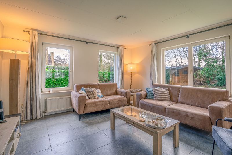 Cozy living room in Holiday Home Honeysuckle 45, De Koog, Texel, with comfortable sofas.