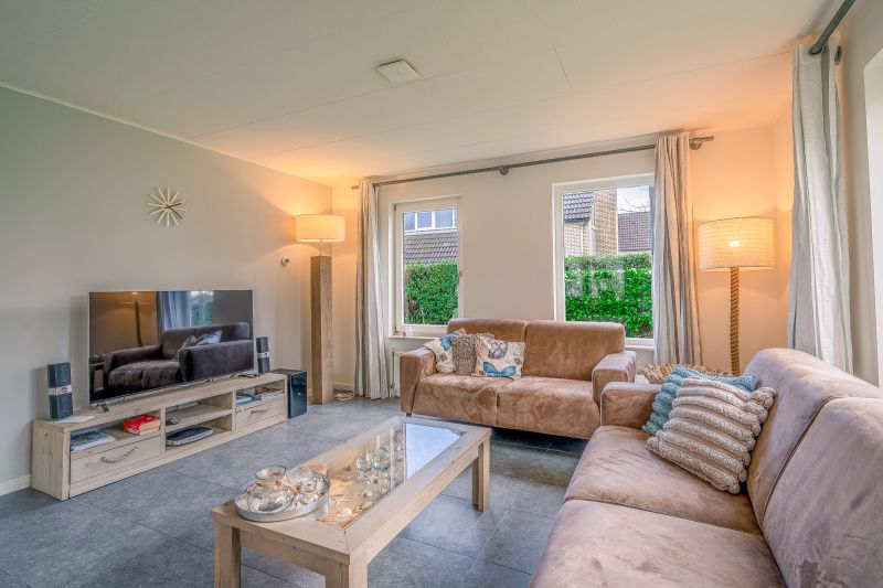 Modern living room with television in Holiday home Honeysuckle 45, De Koog, Texel.