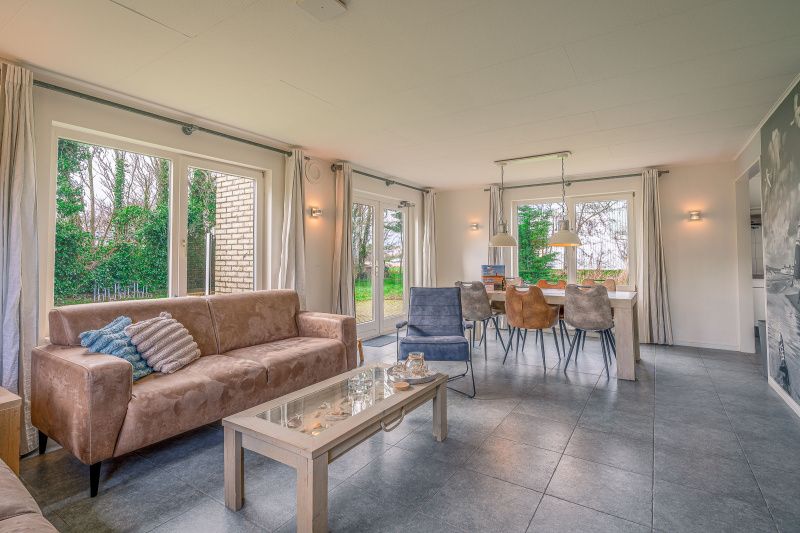 Dining room in Holiday Home Honeysuckle 45, De Koog, Texel, with large dining table and lots of light.