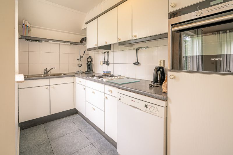 Bedroom with double bed in Holiday home Kamperfoelie 45, De Koog, Texel, overlooking the garden.
