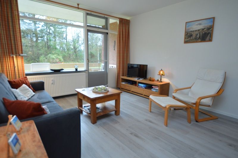 Spacious living room in Apartment Kerckeland 20, De Koog, Texel with modern furnishings and views of nature.