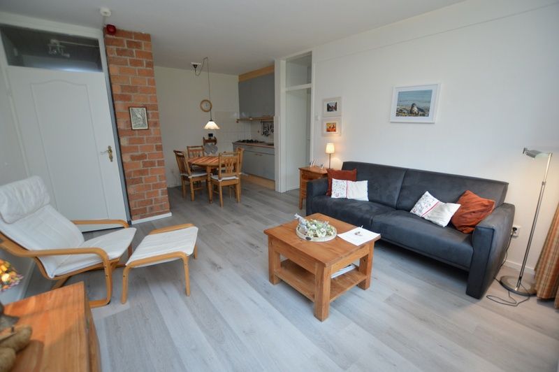 Open living room and kitchen in Apartment Kerckeland 20, De Koog, Texel with cozy atmosphere.