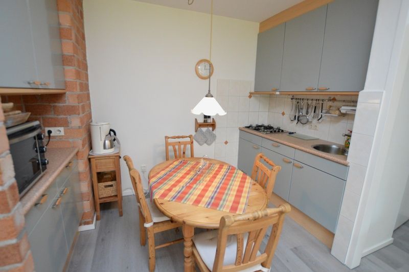 Dining area and kitchen of Apartment Kerckeland 20 in De Koog, Texel with cozy furnishings.