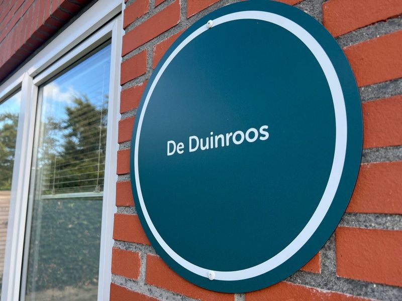 Nameplate of De Duinroos on the facade in De Koog, Texel.