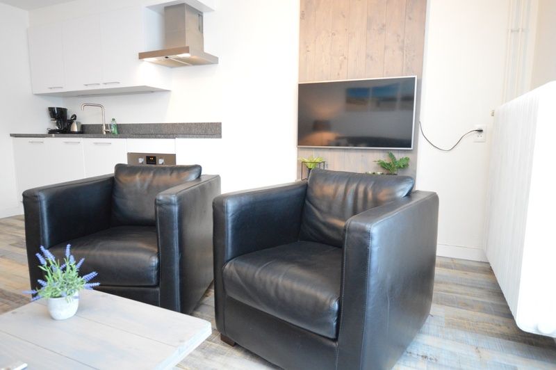 Cozy lounge with leather armchairs in Motel Texel - Apartment 211/1P, De Koog, Texel.