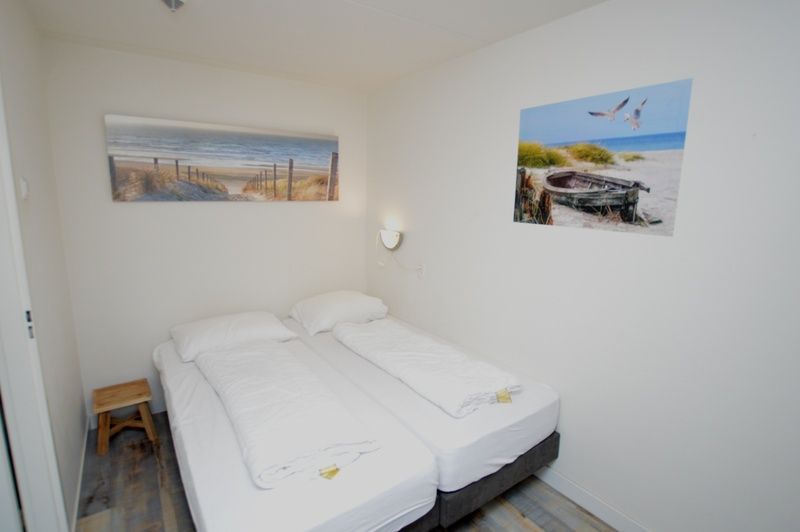 Cozy bedroom in Motel Texel - Apartment 211/1P, De Koog, Texel, with beach decorations.