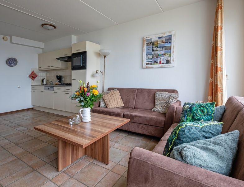 Modern kitchen and sitting area in Resort De Buteriggel Apartment 1, vacation home in De Koog, Texel.
