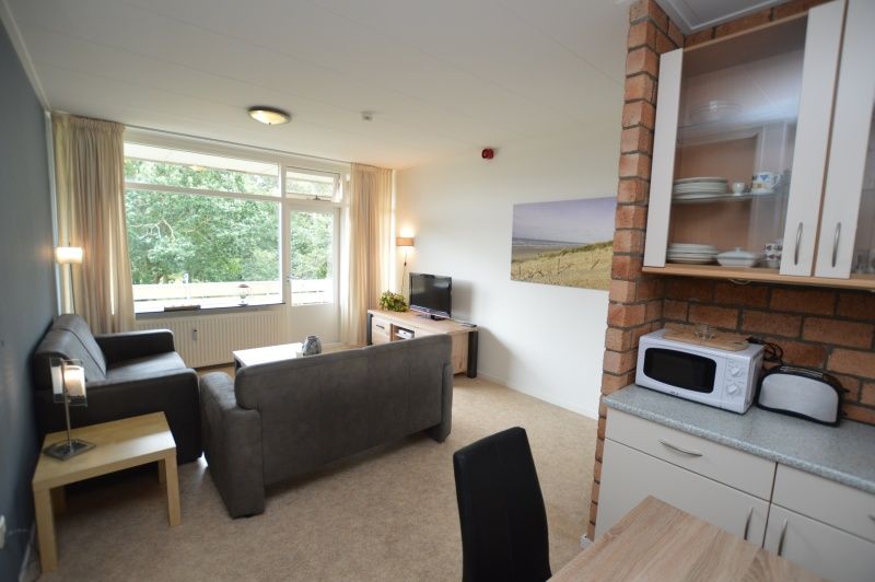 Bright living space of Apartment Kerckeland 122 in De Koog, Texel with comfortable seating.