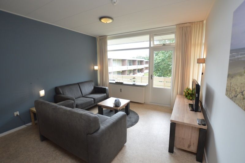 Living room of Apartment Kerckeland 122 in De Koog, Texel with a view of nature.