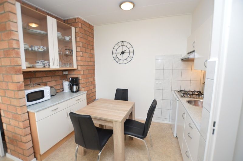 Dining area and kitchen of Apartment Kerckeland 122 on Texel with practical layout.