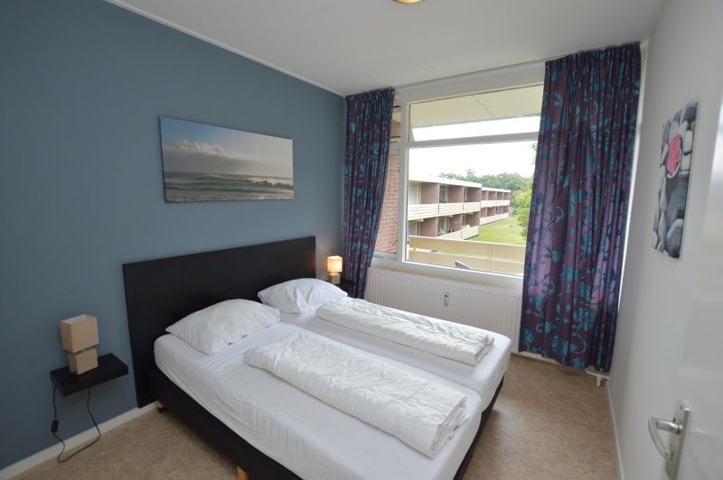 Bedroom in Apartment Kerckeland 122, De Koog, Texel with double bed and view.