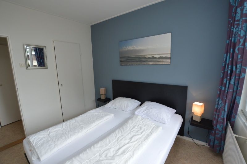 Comfortable bedroom in Apartment Kerckeland 122 on Texel with modern decoration.