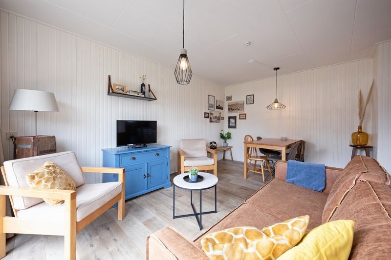 Cozy living room overlooking garden in Windlust vacation home, Texel