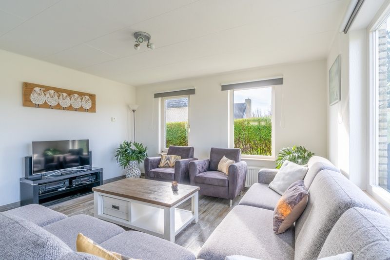 Vacation home Honeysuckle 67 in De Koog Texel with stylish living room and large windows for panoramic views of the Wadden Islands.