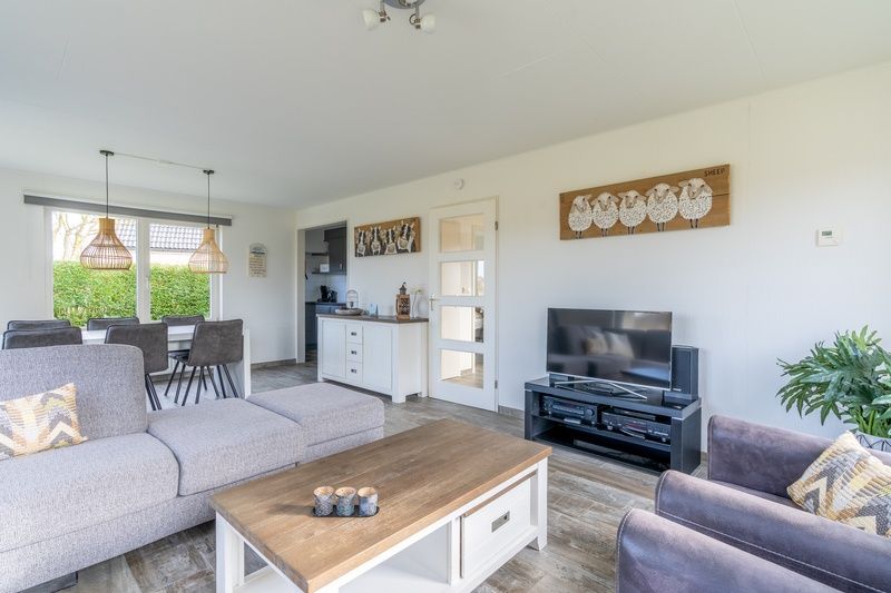 Open living space in Holiday home Honeysuckle 67 De Koog Texel with modern furnishings and access to the Wadden Islands kitchen.