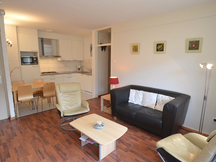 Cozy living room in Apartment Kerckeland 24, De Koog, Texel with modern furnishings and comfortable seating area.