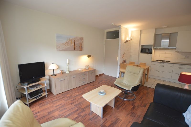 Open kitchen and living room in Apartment Kerckeland 24, De Koog, Texel with cozy atmosphere and modern amenities.