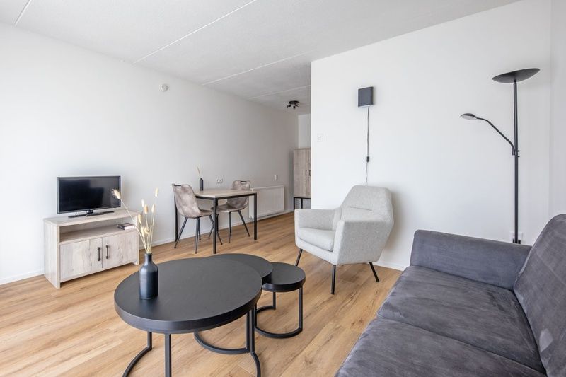 Dining area and living room in Two persons apartment large - first floor, De Koog, Texel for relaxed meals.