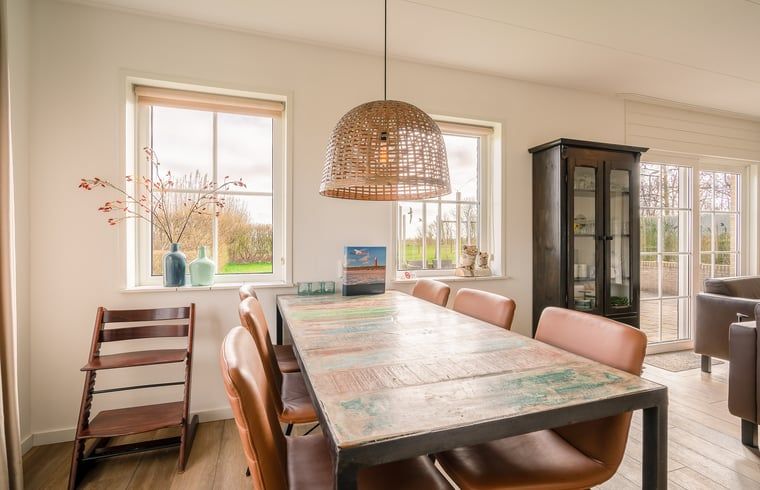 Esszimmer mit Holztisch und Blick auf die Natur in Cottage in De Koog, Ferienhaus auf Texel.