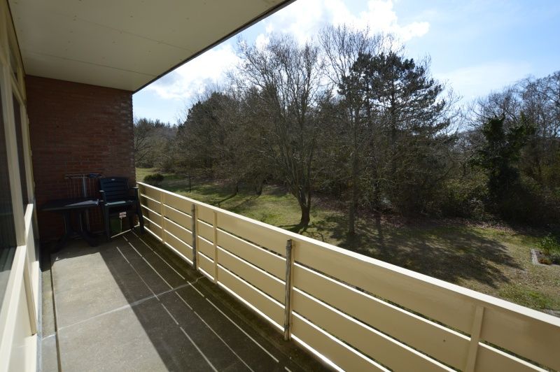 Spacious balcony overlooking nature in Apartment Kerckeland 80, De Koog, Texel, ideal for outdoor relaxation.