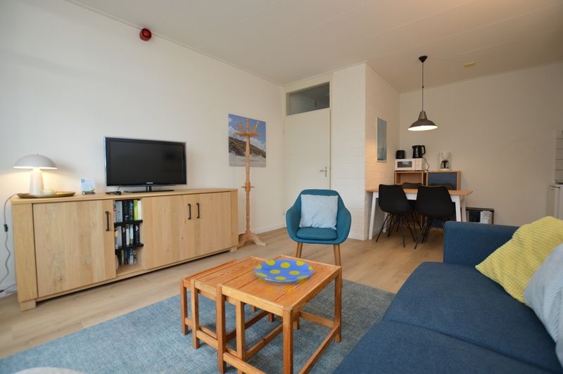Cozy sitting area in Apartment Kerckeland 126, De Koog, Texel, with television and stylish furnishings.