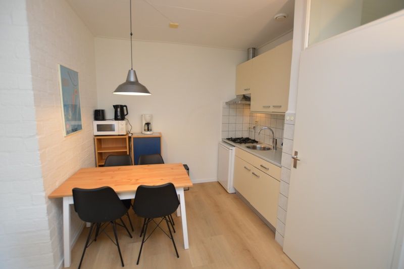 Compact kitchen in Apartment Kerckeland 126, De Koog, Texel, with dining table and modern appliances.