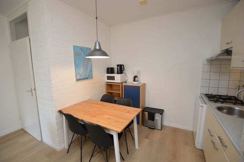 Dining area and kitchen in Apartment Kerckeland 126, De Koog, Texel, ideal for cozy meals.
