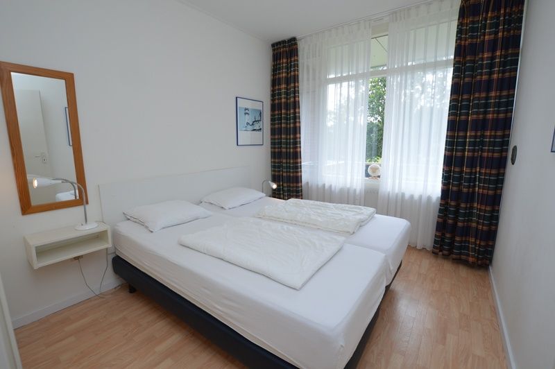 Comfortable bedroom in Apartment Kerckeland 126, De Koog, Texel, with large bed and plenty of daylight.
