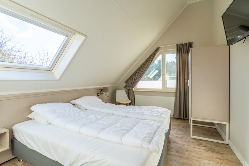 Bright bedroom with skylight in Holiday home Honeysuckle 57, De Koog, Texel offers comfort on the Wadden Islands.