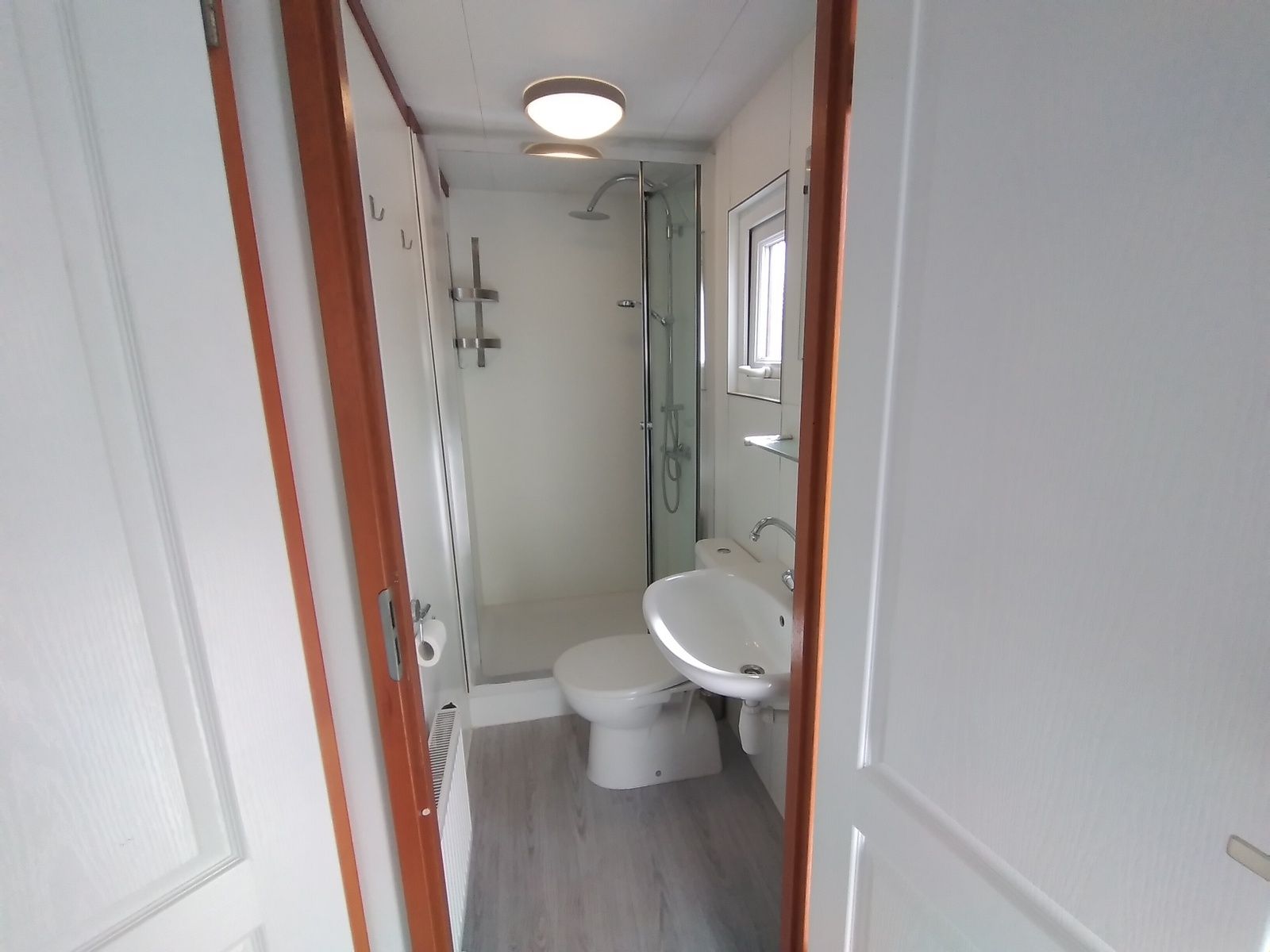Modern bathroom in Chalet Uit en Thuis, De Koog, Texel, with shower and sink.