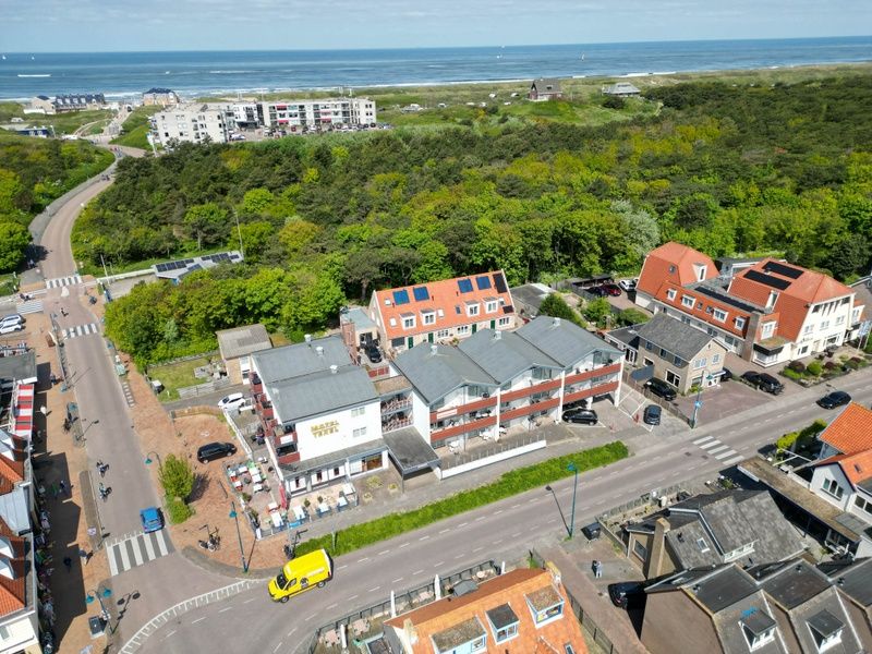 Aerial view of Motel Texel Apartment with bath (B), De Koog, Texel, surrounded by nature and near the coast.