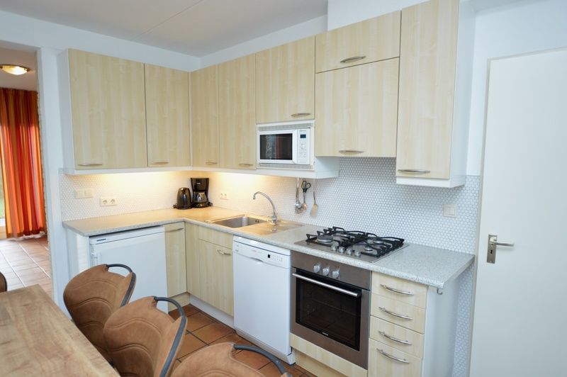 Fully equipped kitchen in Holiday home Stappeland 199, De Koog, Texel, with modern conveniences and spacious layout.