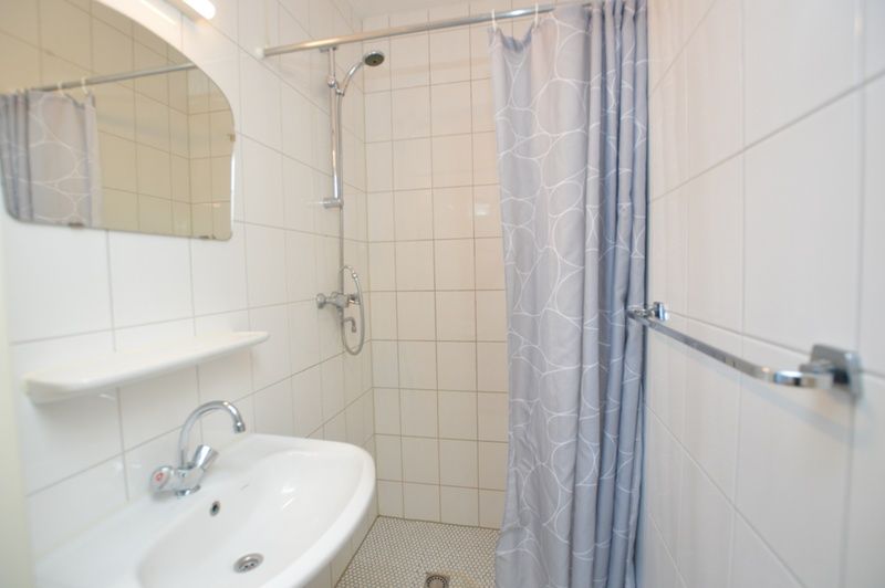 Stylish bathroom in Holiday home Stappeland 199, De Koog, Texel, with shower and modern amenities.