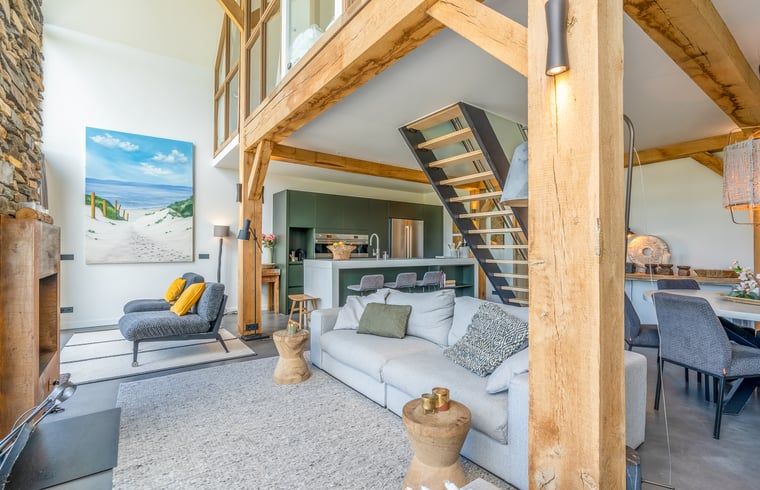 Modern kitchen and dining area in Holiday home in De Koog, Texel, with wooden beams.