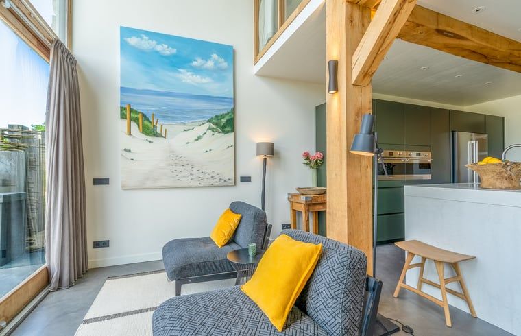 Sitting area with colorful cushions in Holiday cottage in De Koog, Texel, Wadden Islands.