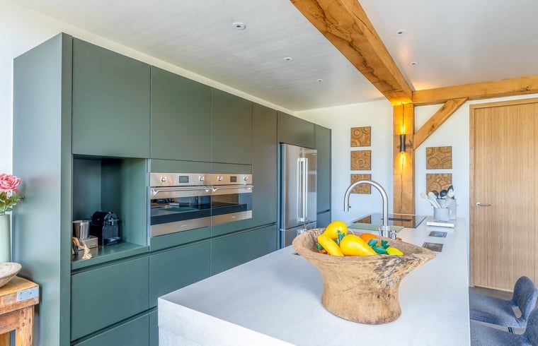 Stylish kitchen in Holiday home in De Koog with modern appliances on Texel.