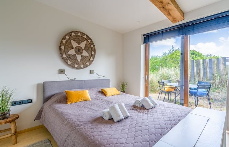 Bedroom in Holiday cottage in De Koog overlooking garden and Texel nature.