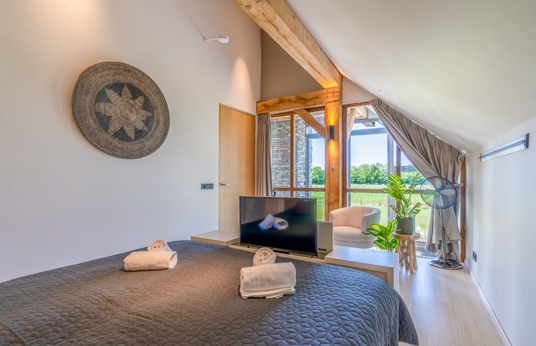 Bedroom with wooden details in Holiday home in De Koog, Texel, Wadden Islands.